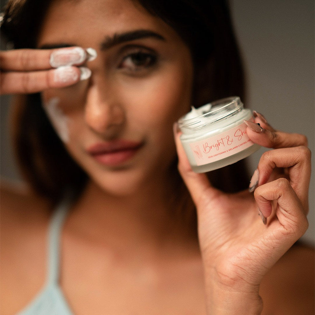 Close-up of a model holding the open Bright & Shine cream jar