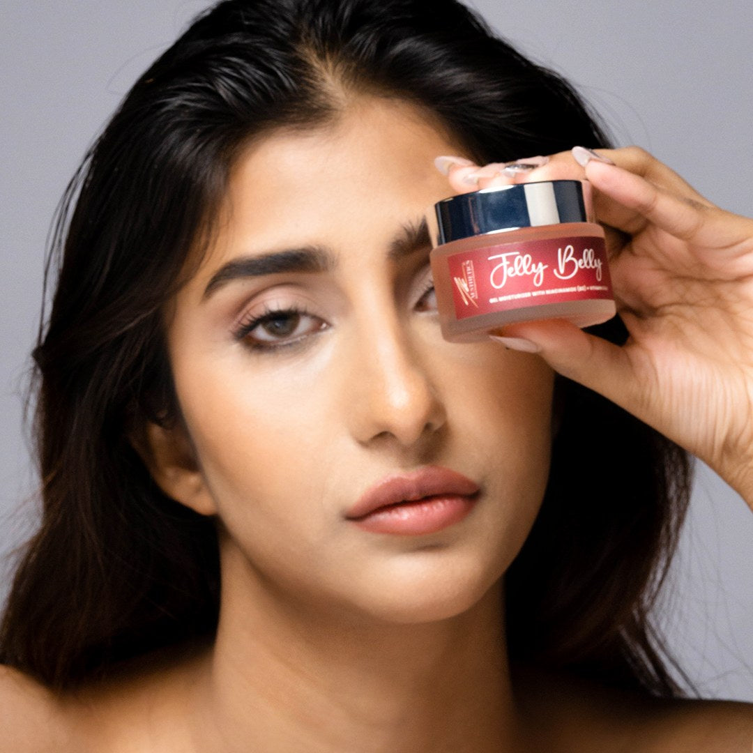 Model holding the Jelly Belly gel moisturiser jar beside her face