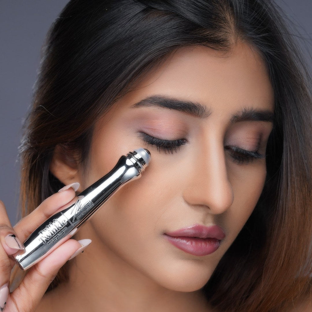 Model applying the Twirl & Twinkle roller ball under her eye